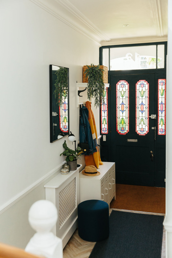 Idee per un piccolo ingresso o corridoio tradizionale con pareti bianche, parquet chiaro e pavimento beige