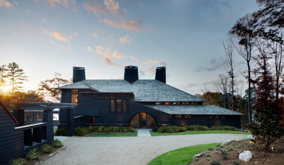 Large rustic black three-story wood house exterior idea with a black roof