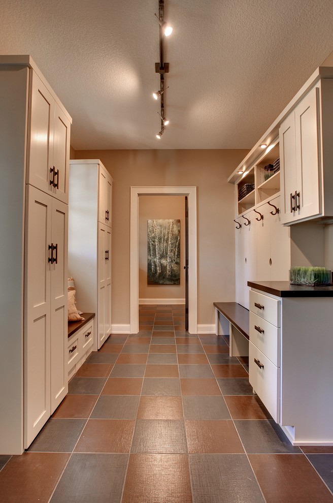 Photo of a traditional laundry room in Minneapolis with wood benchtops, multi-coloured floor and brown benchtop.