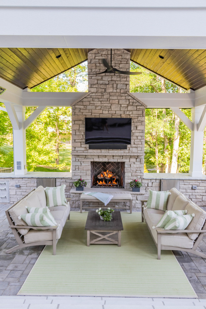 Design ideas for an expansive vintage back patio in St Louis with a fireplace, concrete paving and a gazebo.