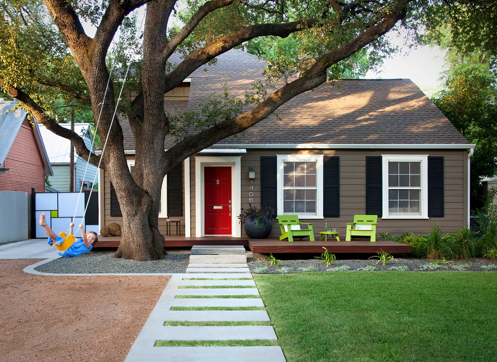 This is an example of a mid-sized modern front yard verandah in Austin with decking.