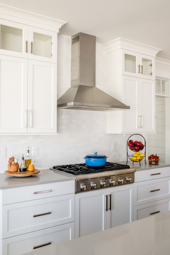 Example of a transitional kitchen design in Providence with an undermount sink, shaker cabinets, quartzite countertops, subway tile backsplash and an island