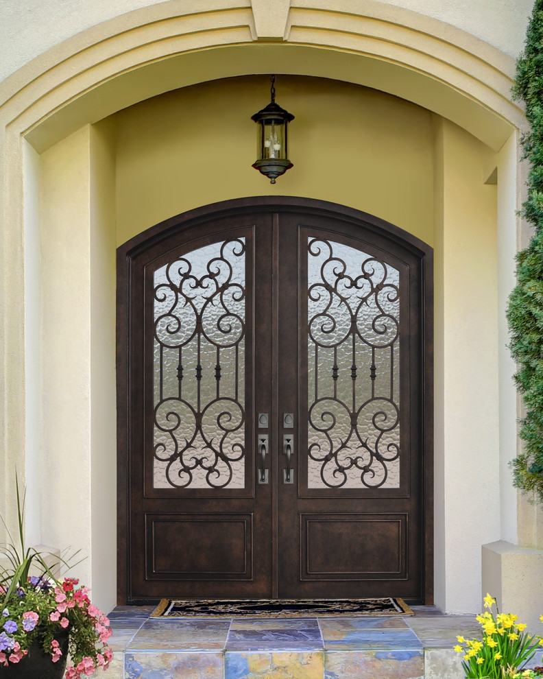 Design ideas for a large mediterranean front door in Tampa with beige walls, a double front door and a metal front door.