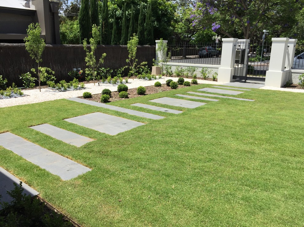 Design ideas for a mid-sized traditional front yard full sun formal garden for summer in Adelaide with natural stone pavers.