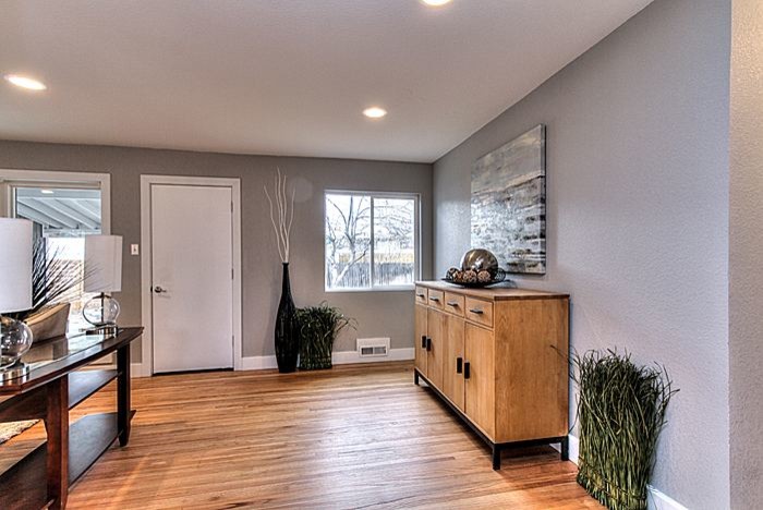 Mid-sized transitional light wood floor front door photo with gray walls and a white front door