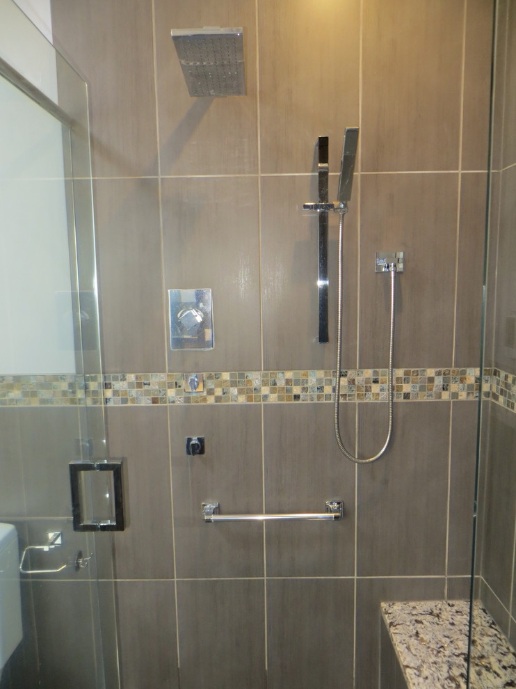 Large contemporary master bathroom in Other with recessed-panel cabinets, dark wood cabinets, a freestanding tub, a corner shower, a one-piece toilet, multi-coloured tile, ceramic tile, grey walls, an undermount sink, granite benchtops, grey floor and a hinged shower door.