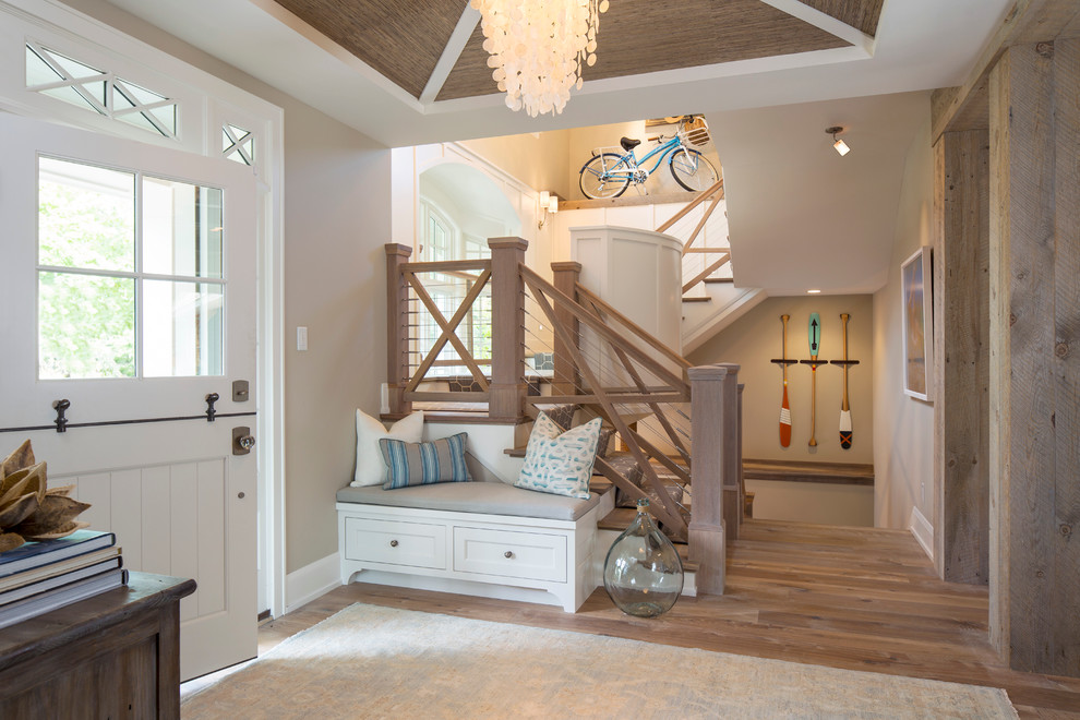 Inspiration for a mid-sized beach style foyer in Minneapolis with medium hardwood floors, a dutch front door, beige walls and a white front door.