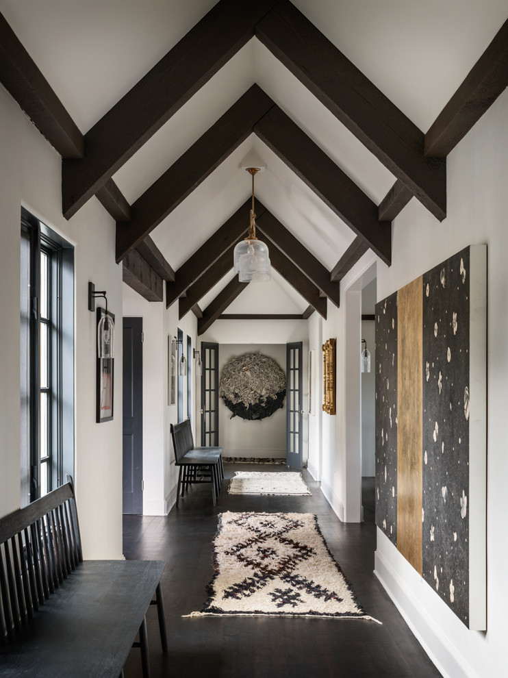 Inspiration for a mediterranean hallway in Portland with white walls, dark hardwood floors and brown floor.