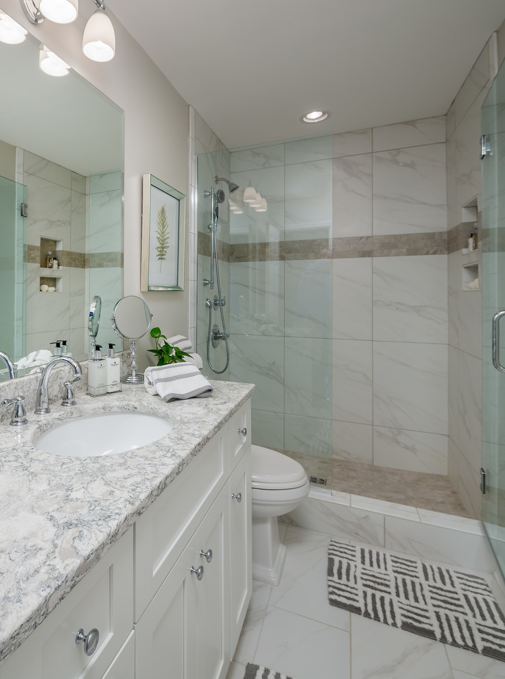 Mid-sized transitional master bathroom in Atlanta with shaker cabinets, white cabinets, an open shower, a two-piece toilet, white tile, porcelain tile, grey walls, porcelain floors, an undermount sink and engineered quartz benchtops.