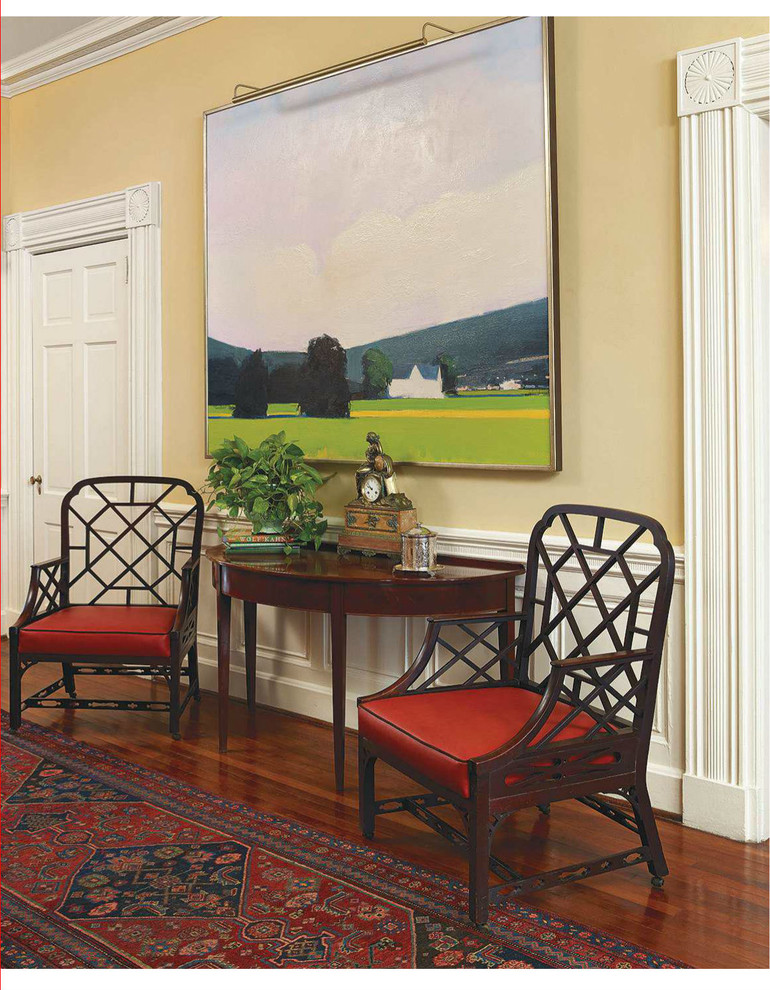 Inspiration for a large traditional entry hall in Charleston with yellow walls, medium hardwood floors, a single front door and a black front door.