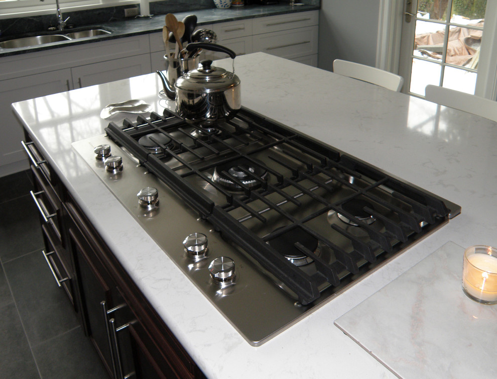 Inspiration for a large transitional l-shaped ceramic tile enclosed kitchen remodel in Baltimore with an undermount sink, shaker cabinets, white cabinets, soapstone countertops, green backsplash, glass tile backsplash, stainless steel appliances and an island