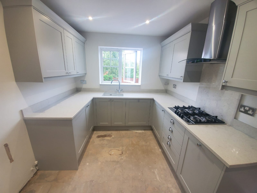 Design ideas for a small modern u-shaped separate kitchen in West Midlands with an integrated sink, shaker cabinets, grey cabinets, quartzite benchtops, white splashback, granite splashback, stainless steel appliances, laminate floors, no island, beige floor and white benchtop.