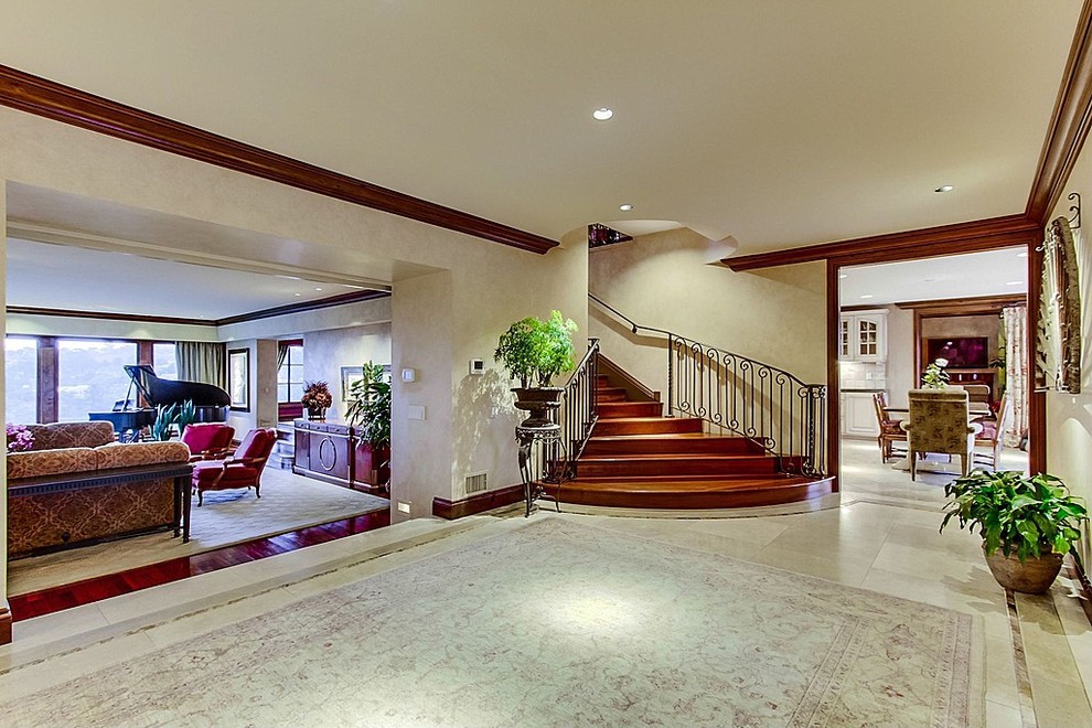 Large mediterranean foyer in Salt Lake City with multi-coloured walls and travertine floors.