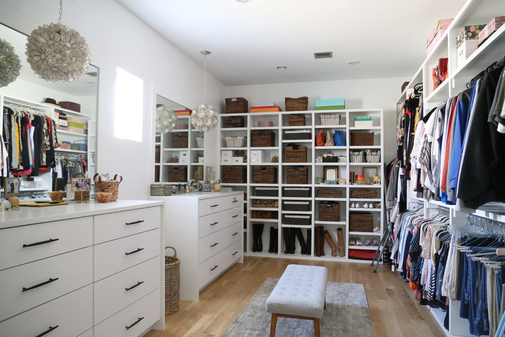 Design ideas for a contemporary gender-neutral walk-in wardrobe in Other with open cabinets, white cabinets, light hardwood floors and beige floor.
