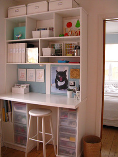 bookshelves on wall with white stool set up for homeschool