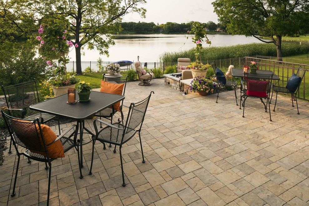 Inspiration for a large arts and crafts backyard patio in Minneapolis with with fireplace and natural stone pavers.
