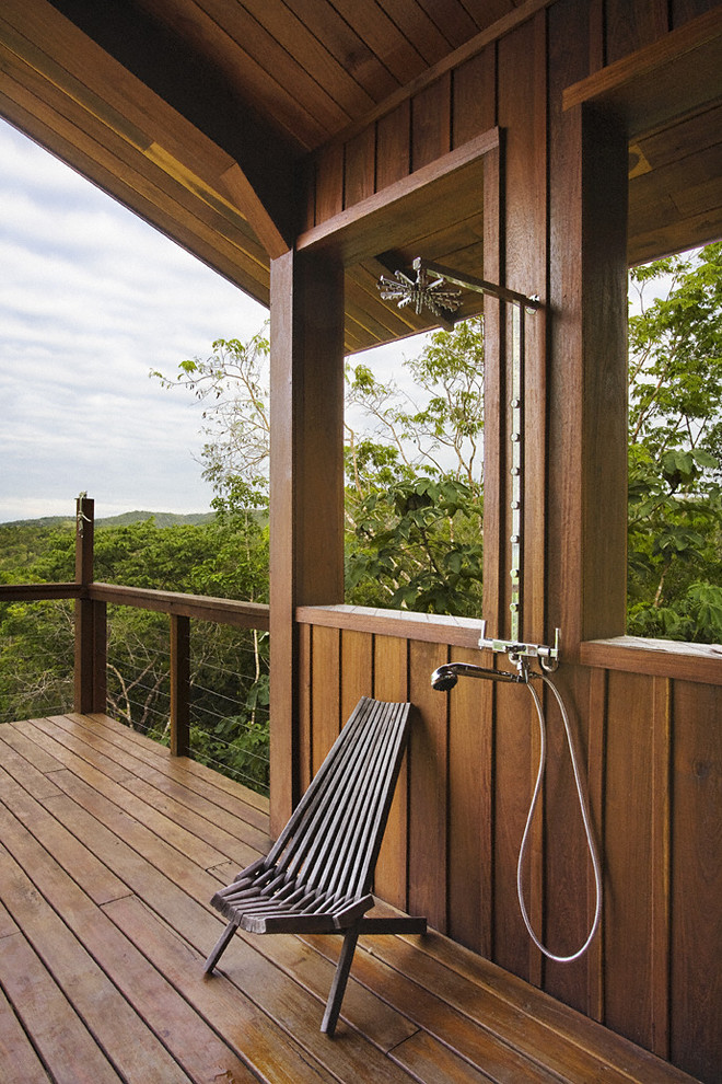 Photo of a large country deck in New York with an outdoor shower.
