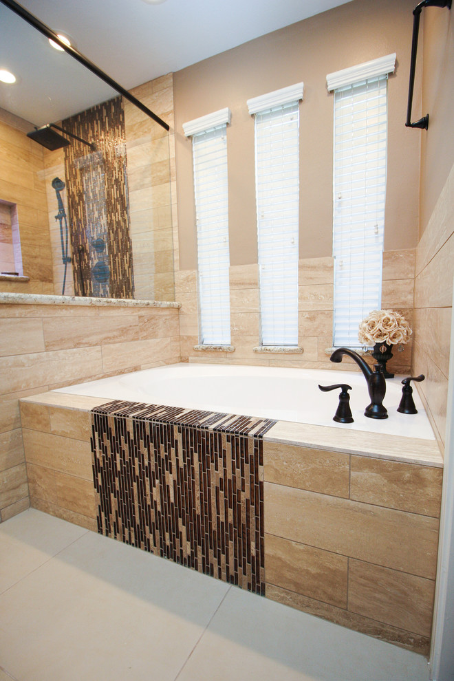 This is an example of a large transitional master bathroom in Houston with shaker cabinets, dark wood cabinets, a drop-in tub, a corner shower, beige tile, porcelain tile, beige walls, porcelain floors, an undermount sink and granite benchtops.