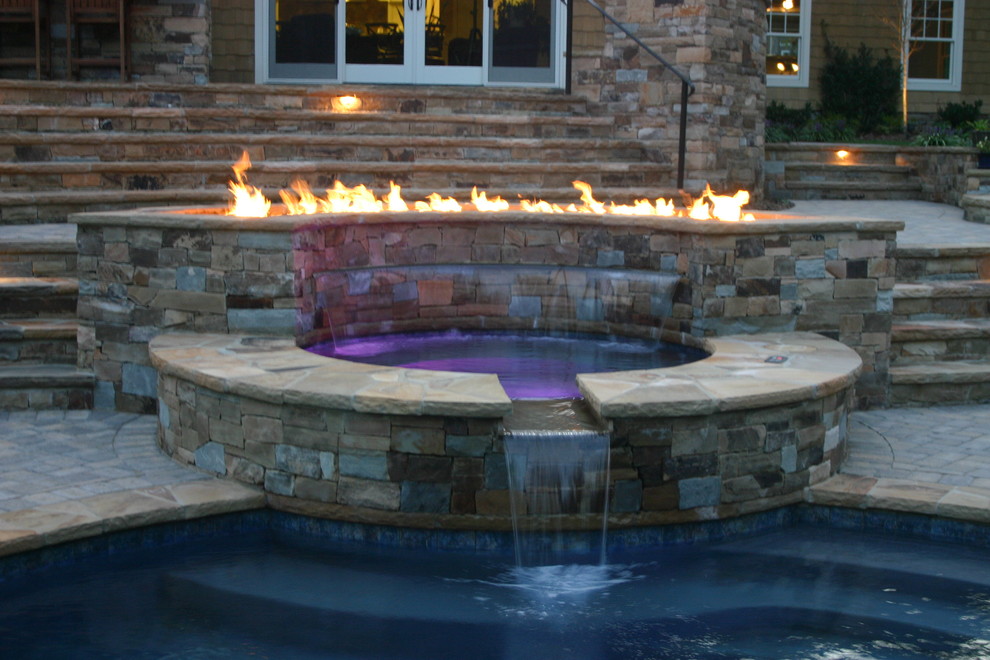 Hot tub - large transitional backyard stone and custom-shaped hot tub idea in Charlotte