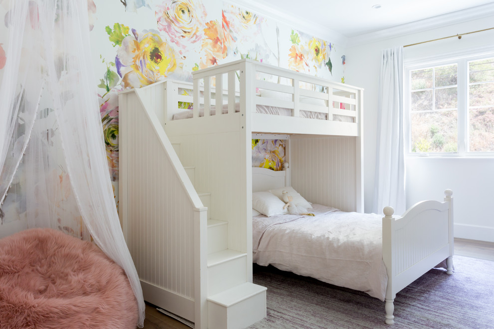 Mid-sized beach style kids' bedroom in Los Angeles with light hardwood floors and multi-coloured walls for kids 4-10 years old and girls.