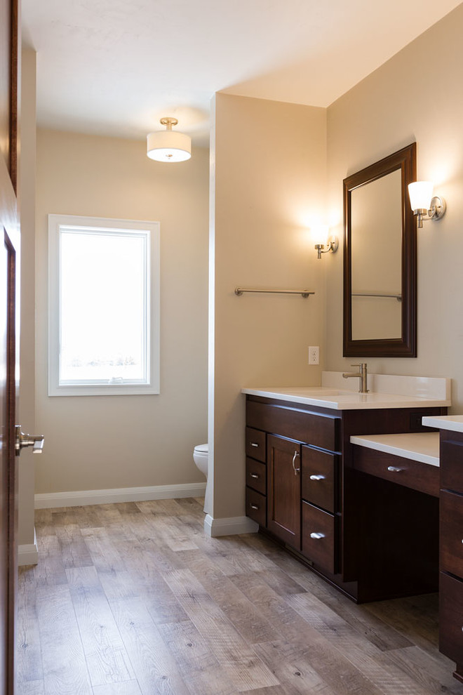 Inspiration for a mid-sized transitional master vinyl floor and brown floor bathroom remodel with medium tone wood cabinets, beige walls and an undermount sink