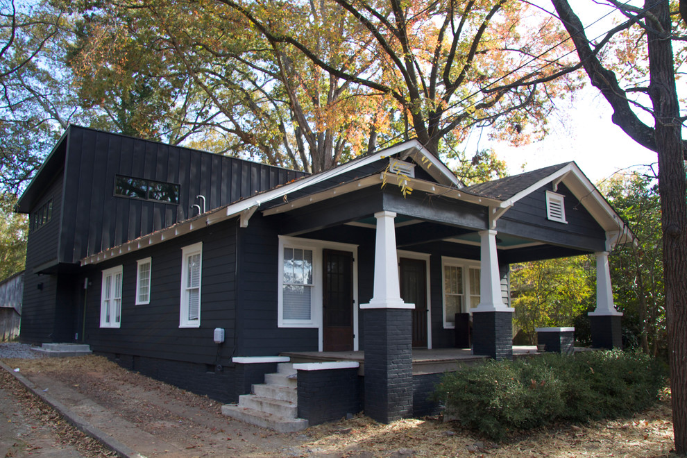 Design ideas for a large contemporary two-storey black house exterior in Atlanta with wood siding and a gable roof.