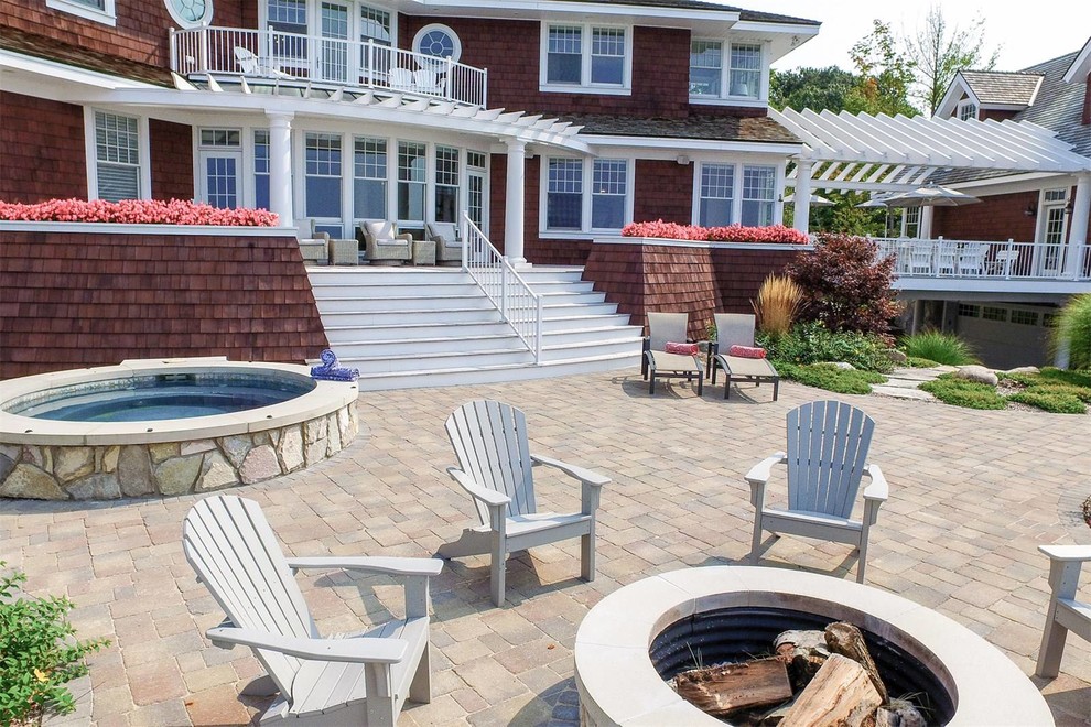 Large beach style three-story wood brown patio photo in New York with a shingle roof