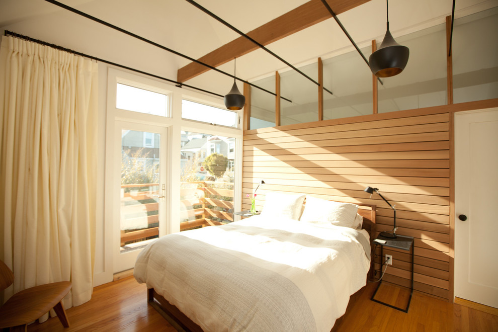 Inspiration for a modern bedroom in San Francisco with medium hardwood floors and no fireplace.