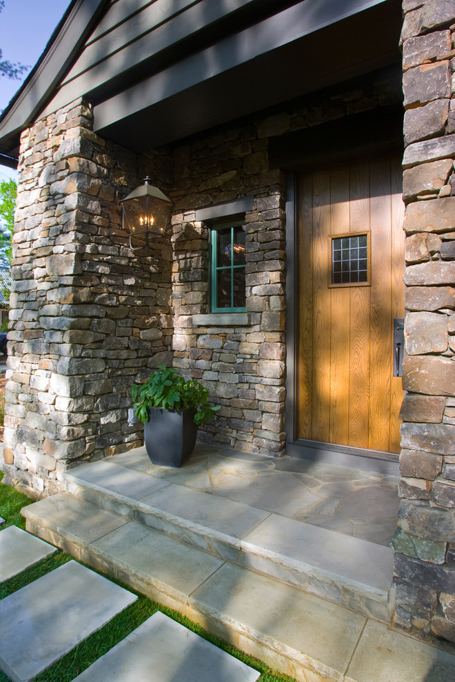 This is an example of a large traditional front door in Charlotte with multi-coloured walls, slate floors, a dutch front door, a medium wood front door and grey floor.