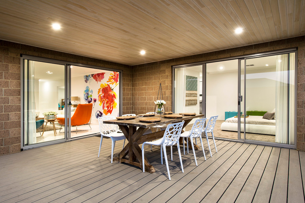This is an example of a mid-sized contemporary courtyard patio in Perth with decking and a roof extension.