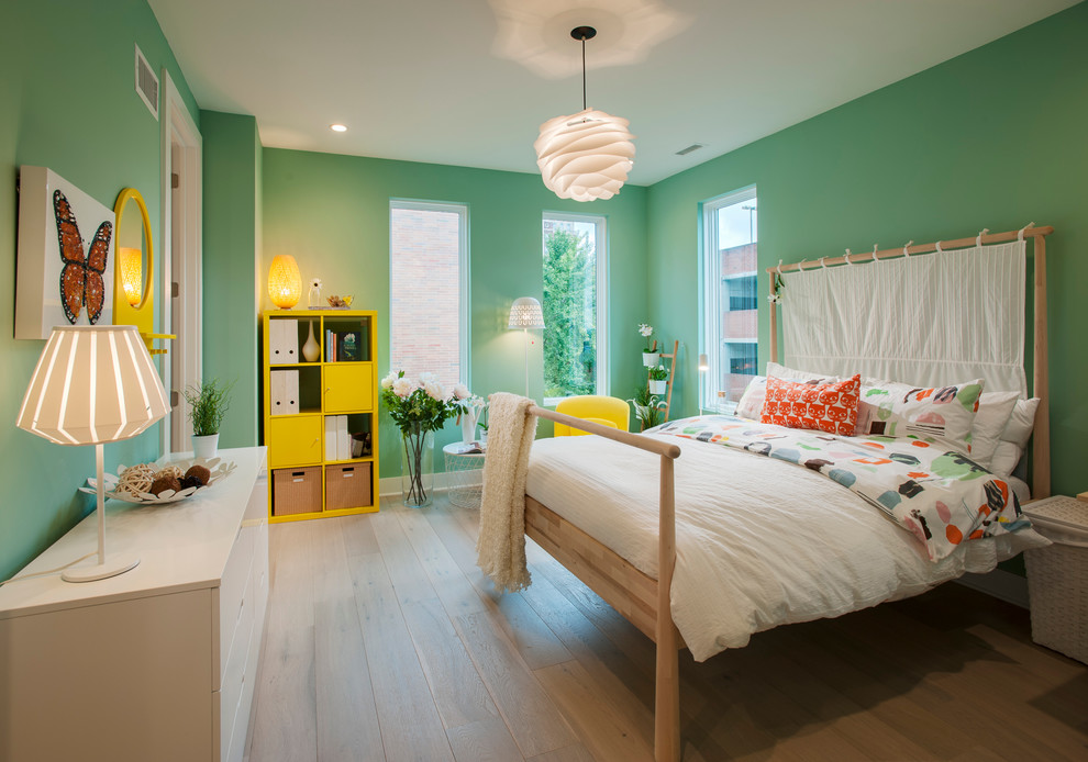 Inspiration for a transitional kids' room for girls in Philadelphia with green walls and light hardwood floors.