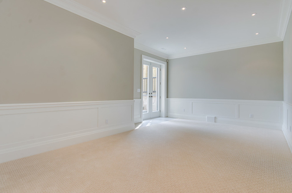 Large transitional walk-out carpeted basement photo in Toronto with beige walls and a standard fireplace