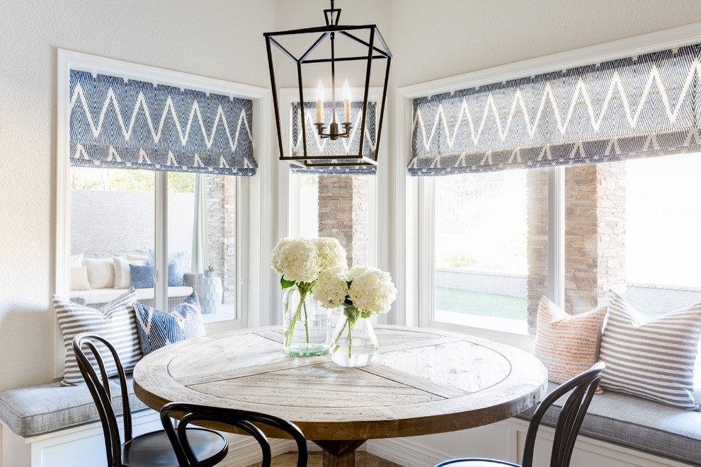 Example of a transitional dining room design in Phoenix with white walls and no fireplace
