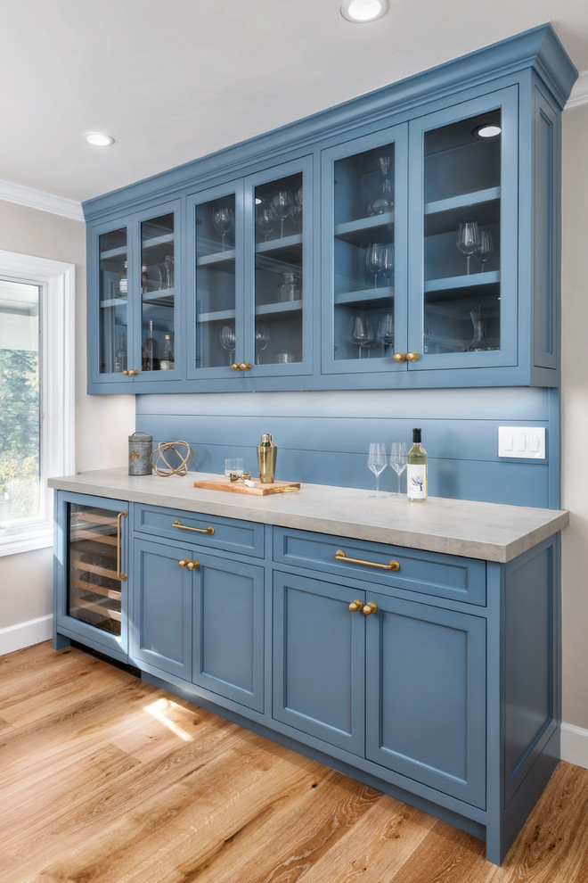 Design ideas for a mid-sized country single-wall home bar in San Francisco with beaded inset cabinets, blue cabinets, quartz benchtops, blue splashback, timber splashback, medium hardwood floors, brown floor and grey benchtop.