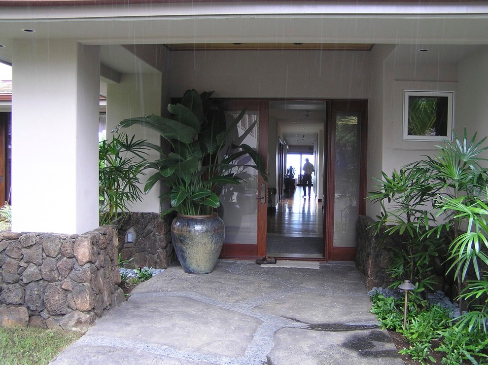 Photo of a mid-sized tropical foyer in Hawaii with yellow walls, slate floors, a double front door and a dark wood front door.
