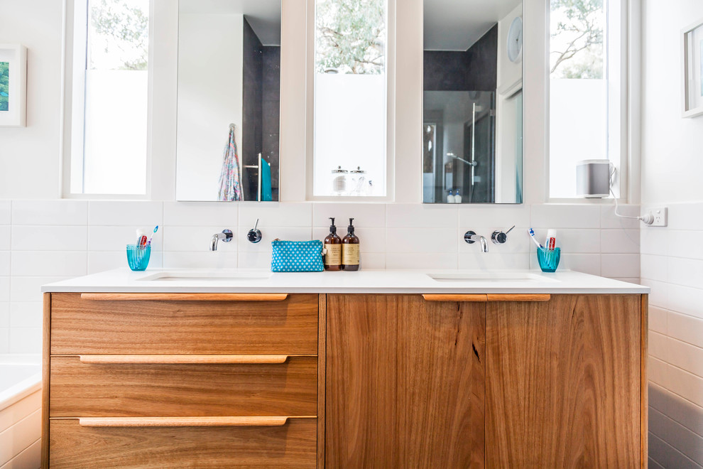 Design ideas for a large midcentury master bathroom in Melbourne with furniture-like cabinets, medium wood cabinets, an alcove tub, an open shower, white tile, subway tile, ceramic floors, an undermount sink, engineered quartz benchtops and grey floor.