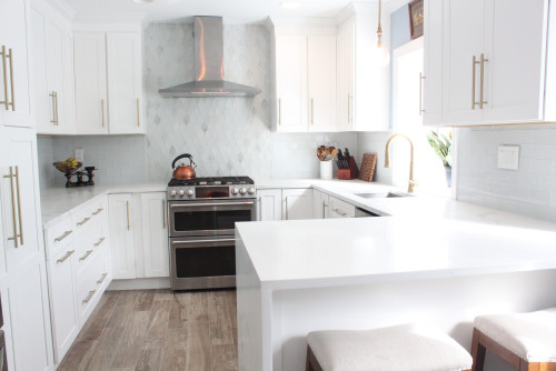 White shaker kitchen with stainless steel chimney hood in Philadelphia.