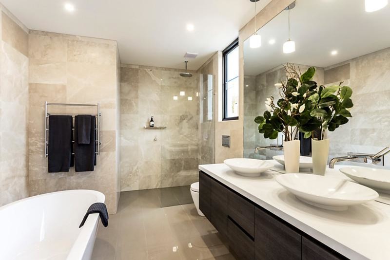 Inspiration for a contemporary master bathroom in Melbourne with flat-panel cabinets, dark wood cabinets, a freestanding tub, an alcove shower, a one-piece toilet, beige tile, beige walls, porcelain floors, a vessel sink, beige floor and an open shower.