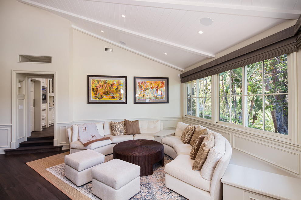 Photo of a transitional living room in Los Angeles with white walls, dark hardwood floors and brown floor.