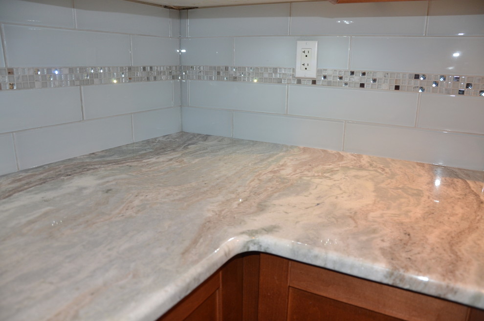 Home design - small transitional u-shaped porcelain tile home design idea in Toronto with a double-bowl sink, beaded inset cabinets, medium tone wood cabinets, granite countertops, white backsplash, glass tile backsplash, stainless steel appliances and no island