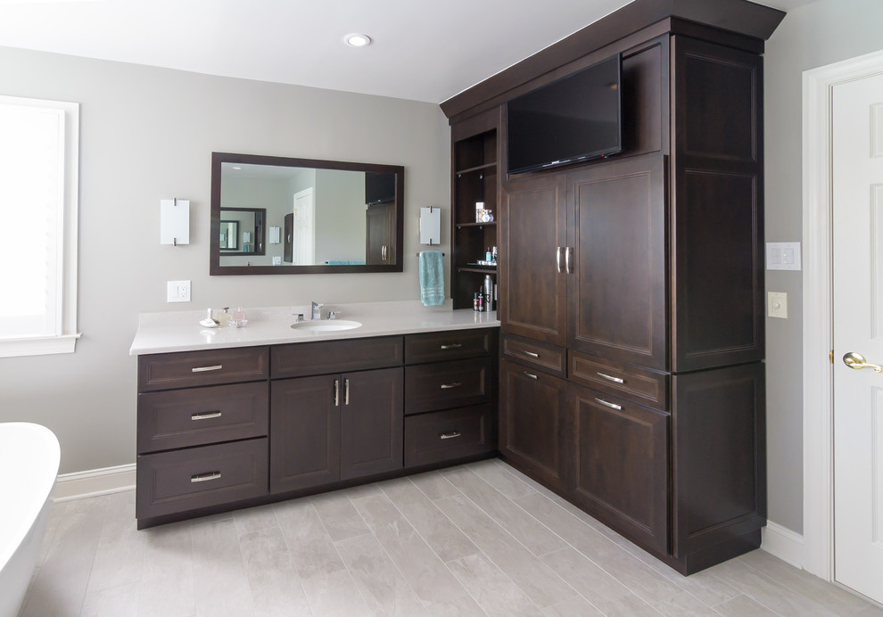 Large contemporary master bathroom in Philadelphia with raised-panel cabinets, dark wood cabinets, a freestanding tub, a corner shower, grey walls, an undermount sink, wood benchtops, beige floor, a hinged shower door and beige benchtops.
