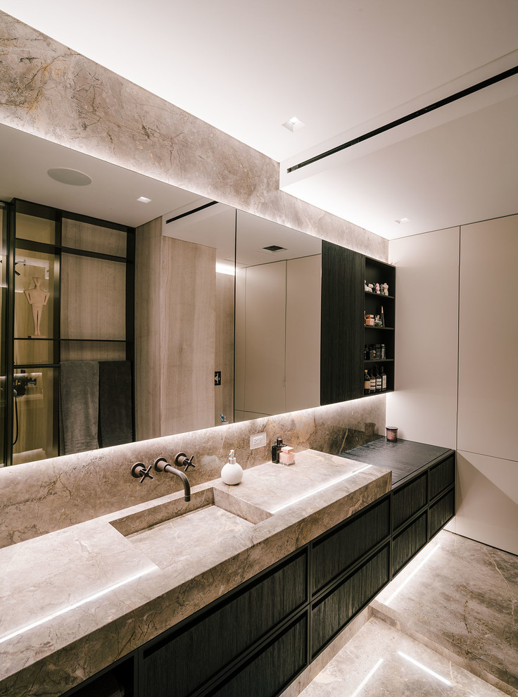 Large contemporary master bathroom in New York with black cabinets, an integrated sink, grey floor, grey benchtops, beige walls, marble floors and marble benchtops.