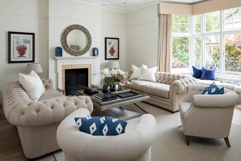 Design ideas for a mid-sized traditional formal living room in London with beige walls and a standard fireplace.