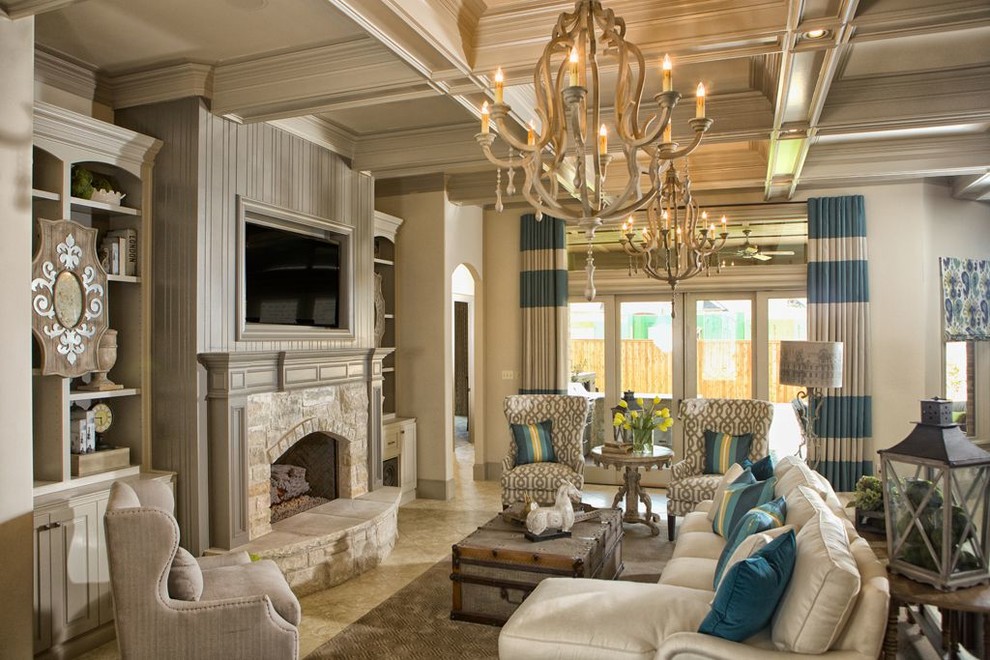 This is an example of a mid-sized traditional formal open concept living room in Austin with beige walls, limestone floors, a standard fireplace, a stone fireplace surround, a wall-mounted tv and beige floor.