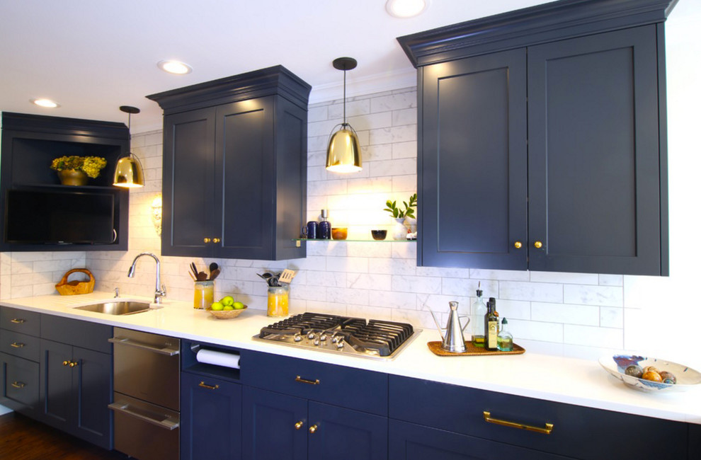 This is an example of a mid-sized transitional u-shaped kitchen in New York with an undermount sink, shaker cabinets, blue cabinets, quartz benchtops, grey splashback, subway tile splashback, stainless steel appliances, dark hardwood floors, a peninsula and brown floor.