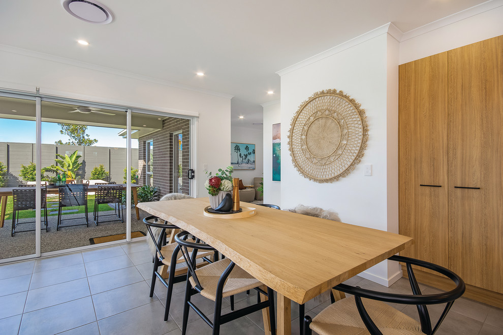 This is an example of a beach style dining room in Sunshine Coast.