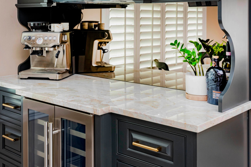 Mid-sized transitional porcelain tile and white floor kitchen photo in Orlando with a farmhouse sink, recessed-panel cabinets, light wood cabinets, quartz countertops, marble backsplash and stainless steel appliances