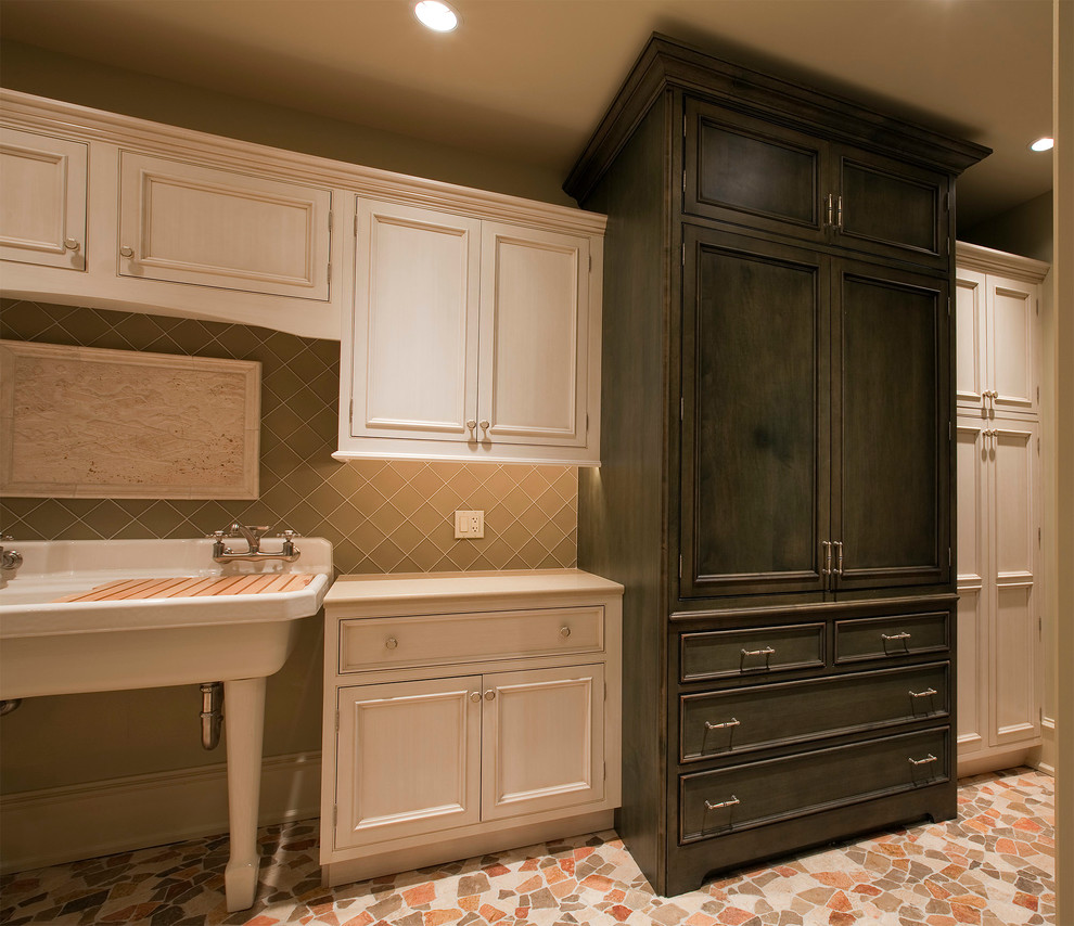 This is an example of a large traditional u-shaped laundry room in Chicago with a farmhouse sink and beaded inset cabinets.