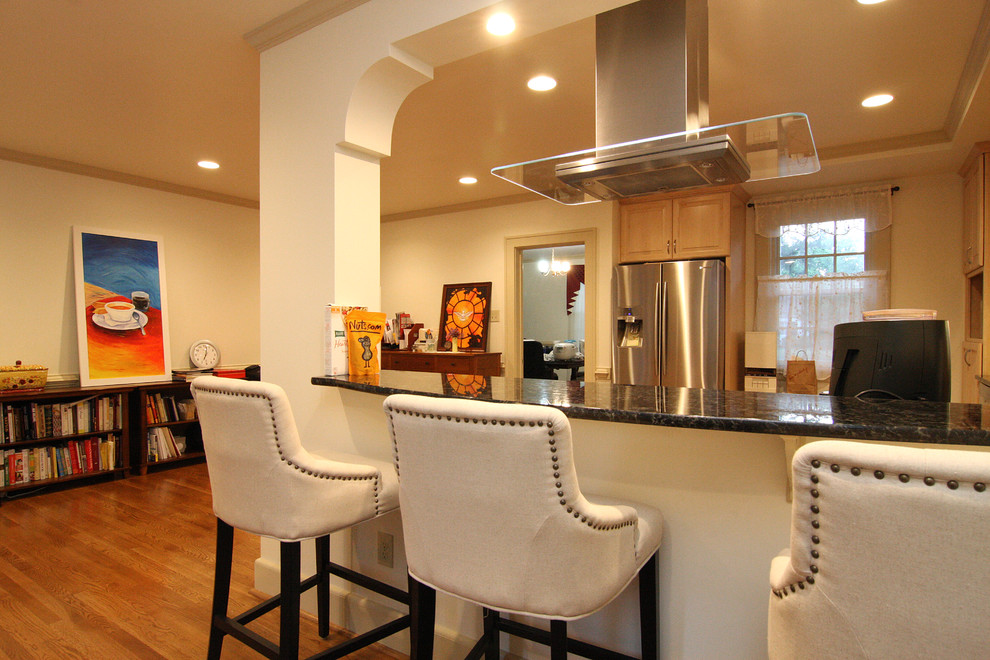 Inspiration for a huge transitional l-shaped medium tone wood floor open concept kitchen remodel with an undermount sink, raised-panel cabinets, light wood cabinets, granite countertops, blue backsplash, glass tile backsplash and stainless steel appliances