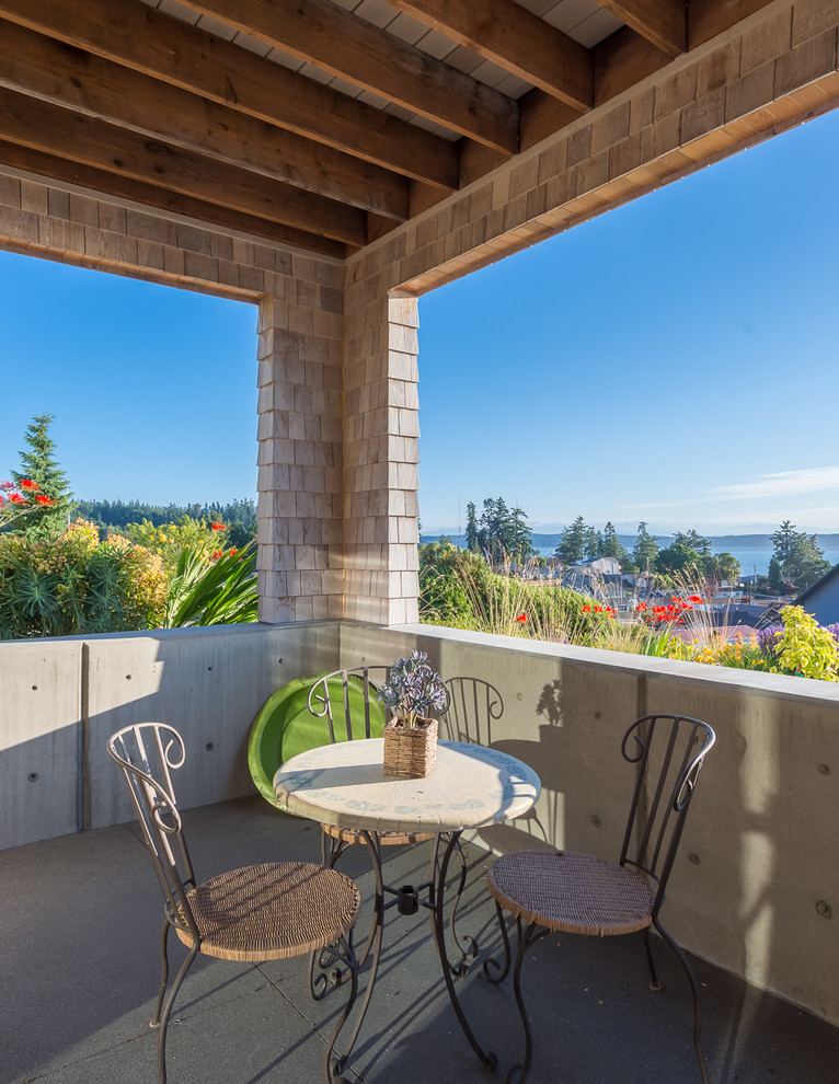 Inspiration for a transitional balcony remodel in Seattle with a roof extension